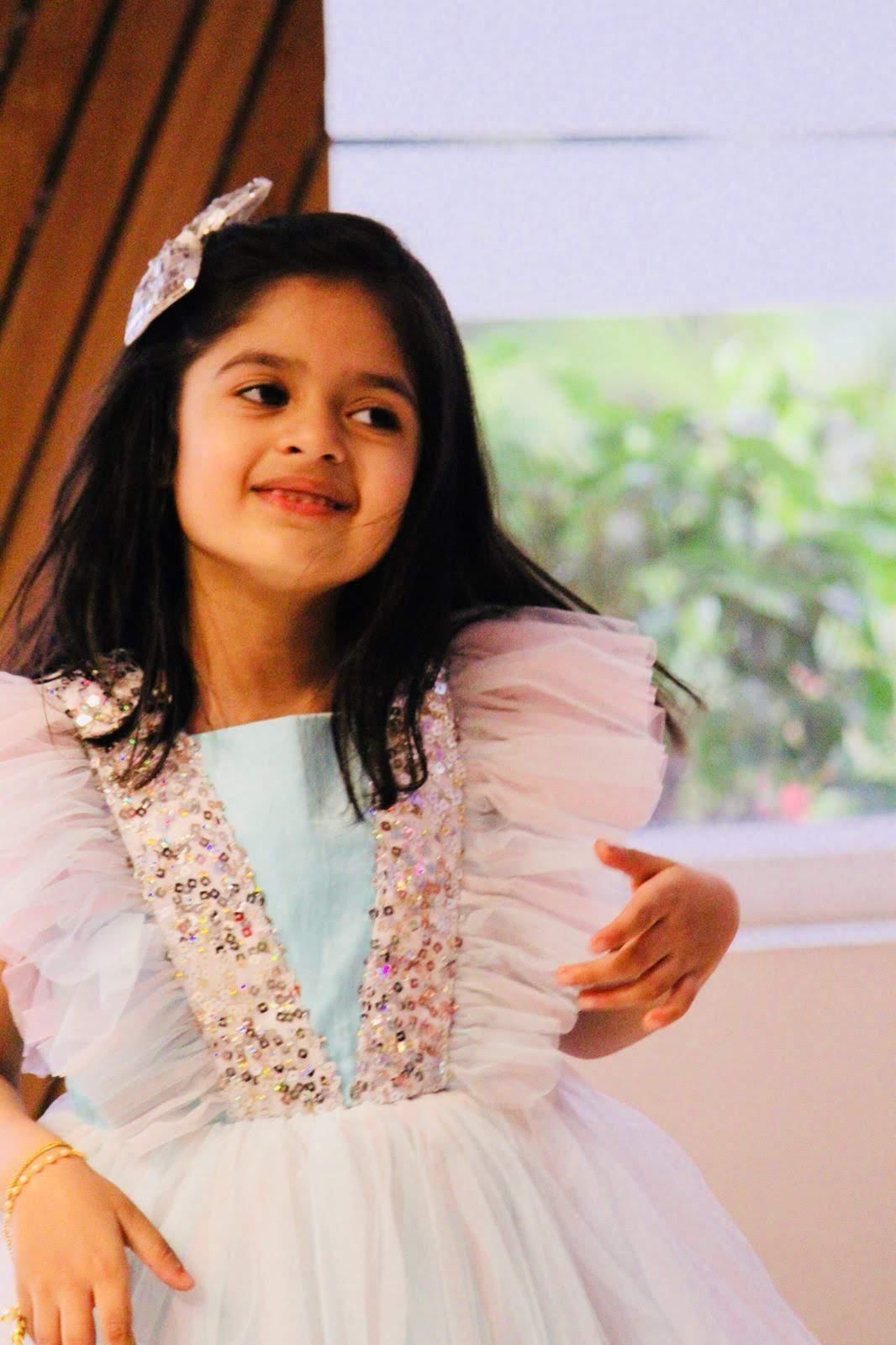 Unnati Raj smiling in a sequined party dress